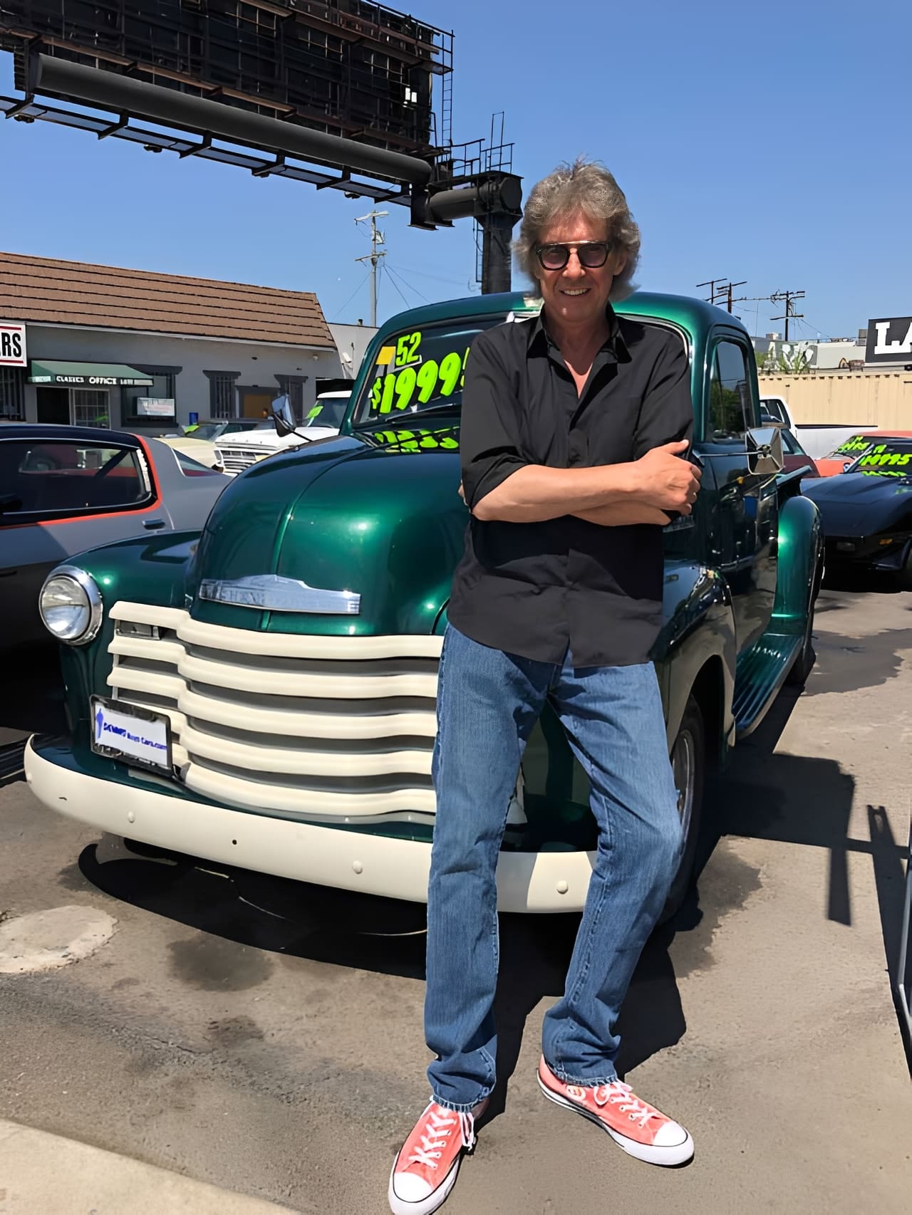 Man standing in front of vintage truck.