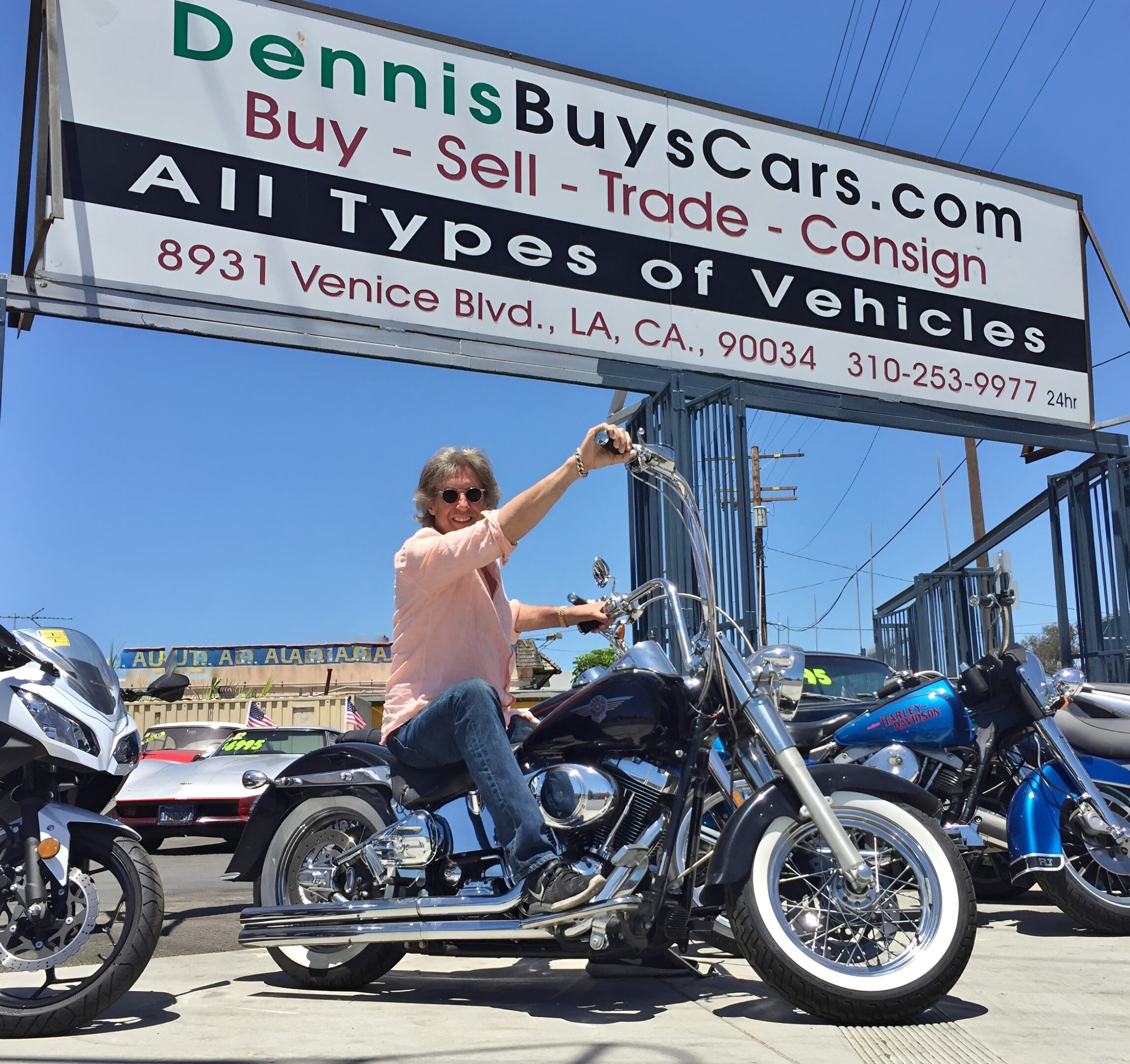 Person on motorcycle at vehicle dealership.