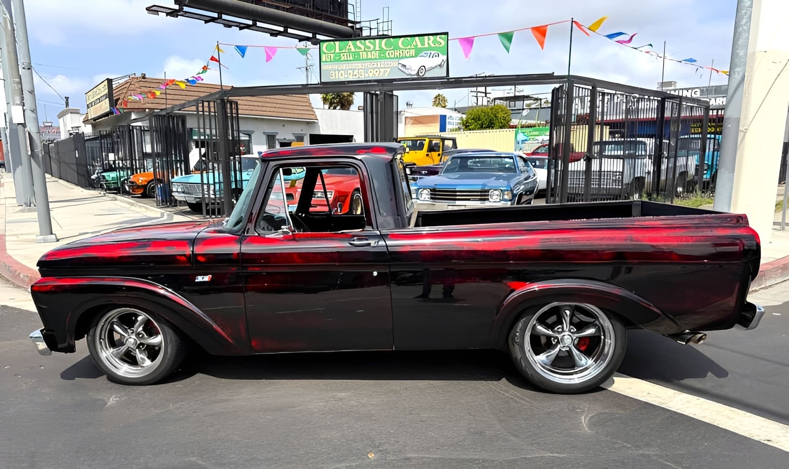 Vintage black truck parked on street.