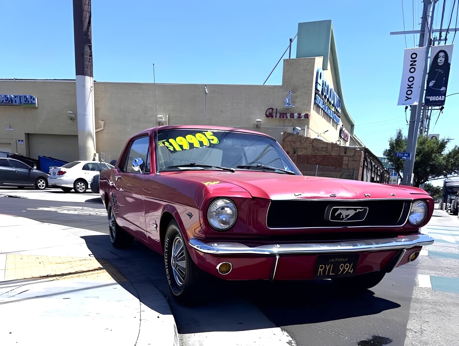 Red vintage car parked on street corner.