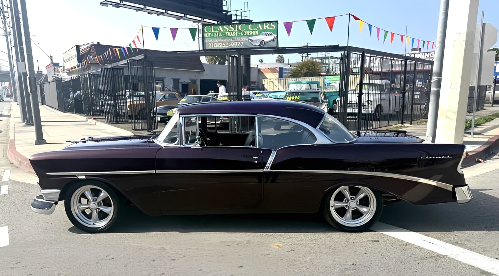 Classic black car parked on street.