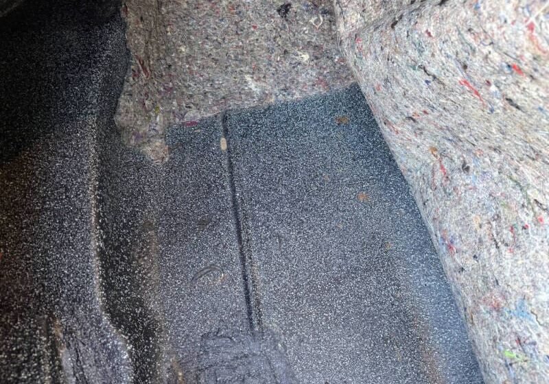 Car trunk interior with textured lining material.