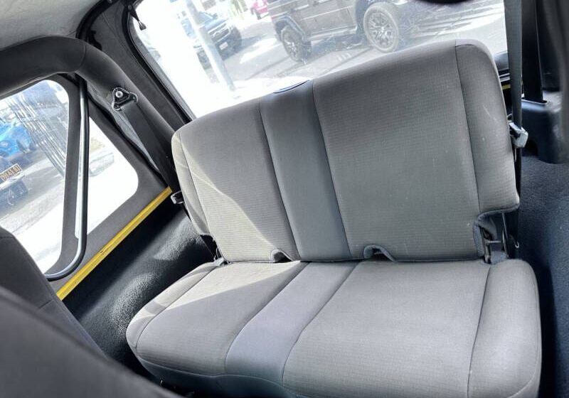 Backseat of a car with gray upholstery.