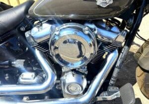 Motorcycle engine with chrome details in sunlight.