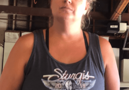 Woman wearing a Sturgis 2019 tank top.