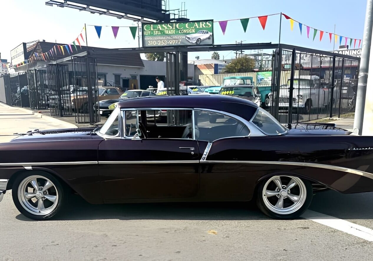 Classic black car parked on street.