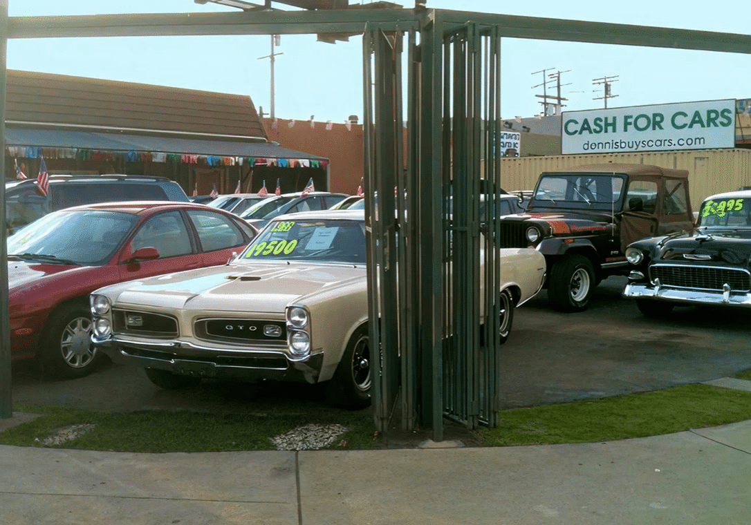 Used cars displayed at dealership with prices.